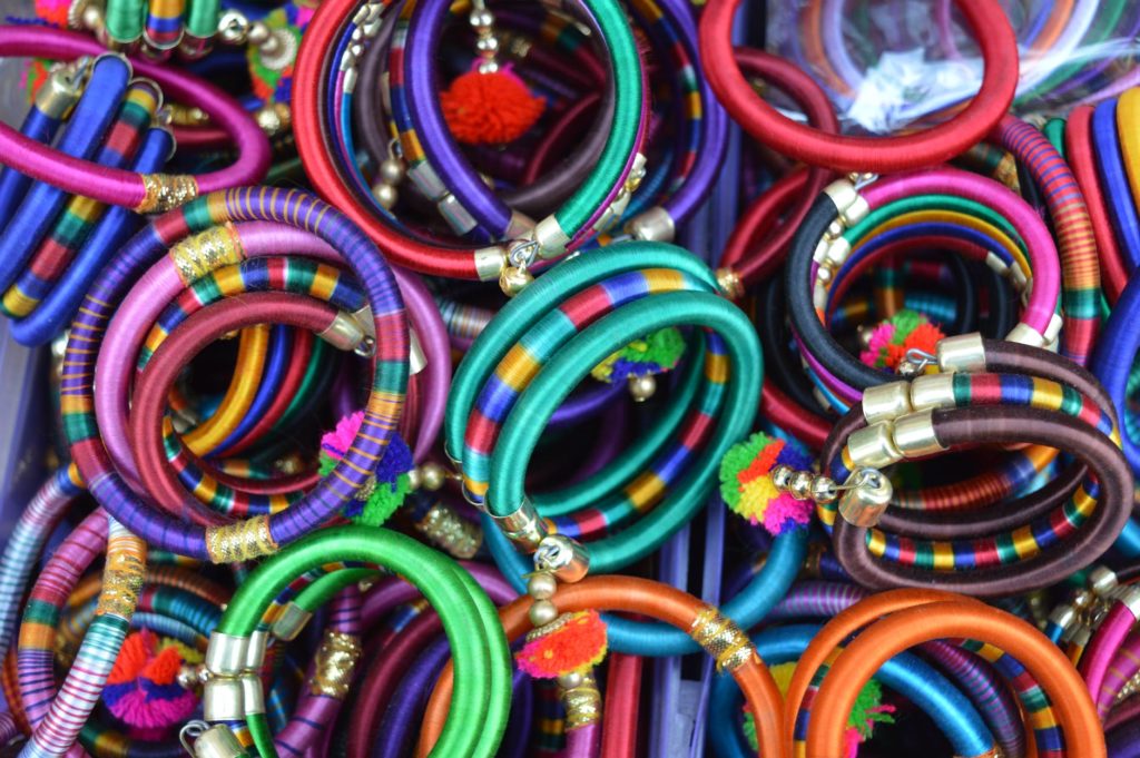 pile of women s assorted colored bangles